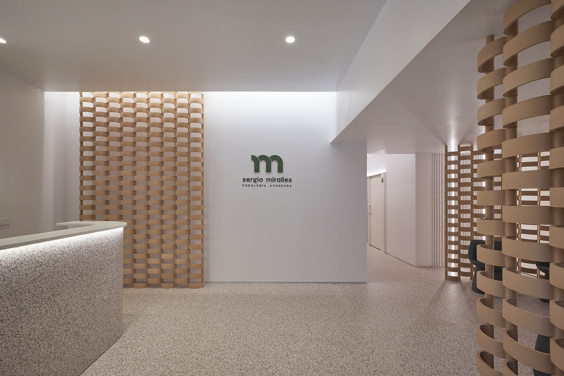 Aplicación de la marca Sergio Miralles en pared al lado del mostrador de recepción, Logotipo corpóreo.