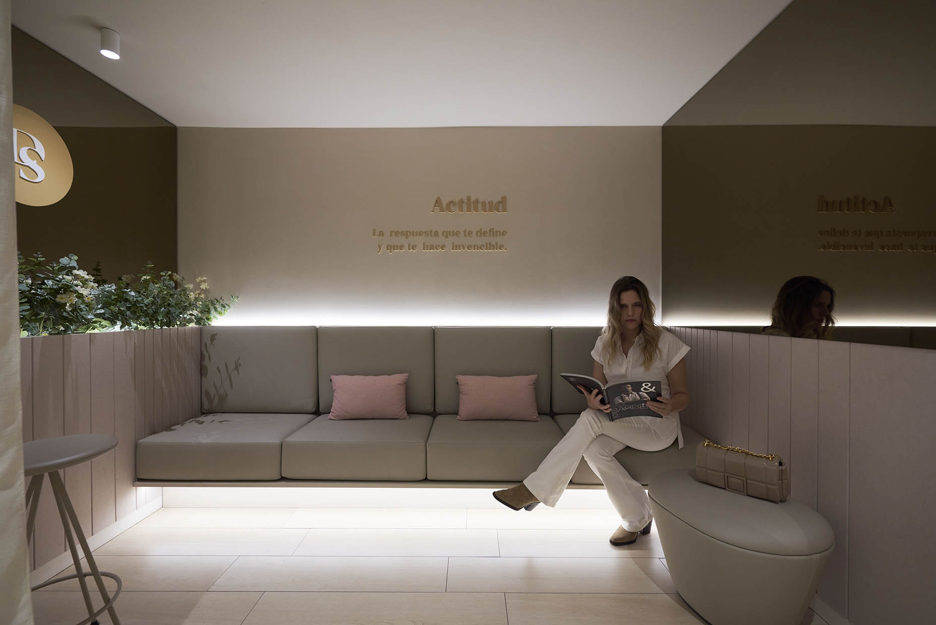 Zona espera con banco tapizado e iluminación indirecta